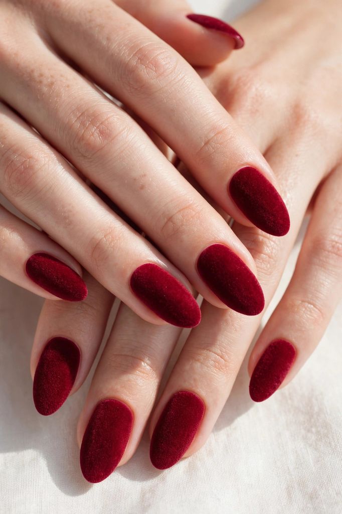 cranberry velvet almond nail design with delicate hand-painted details on almond nails in deep tones, amber and warm cinnamon