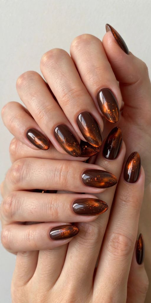 fireplace glow almond nail design with delicate hand-painted details on almond nails in deep tones, evergreen and berry red